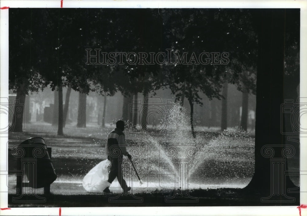 1990 Kevin Smith picks up garbage at Hermann Park in Houston - Historic Images