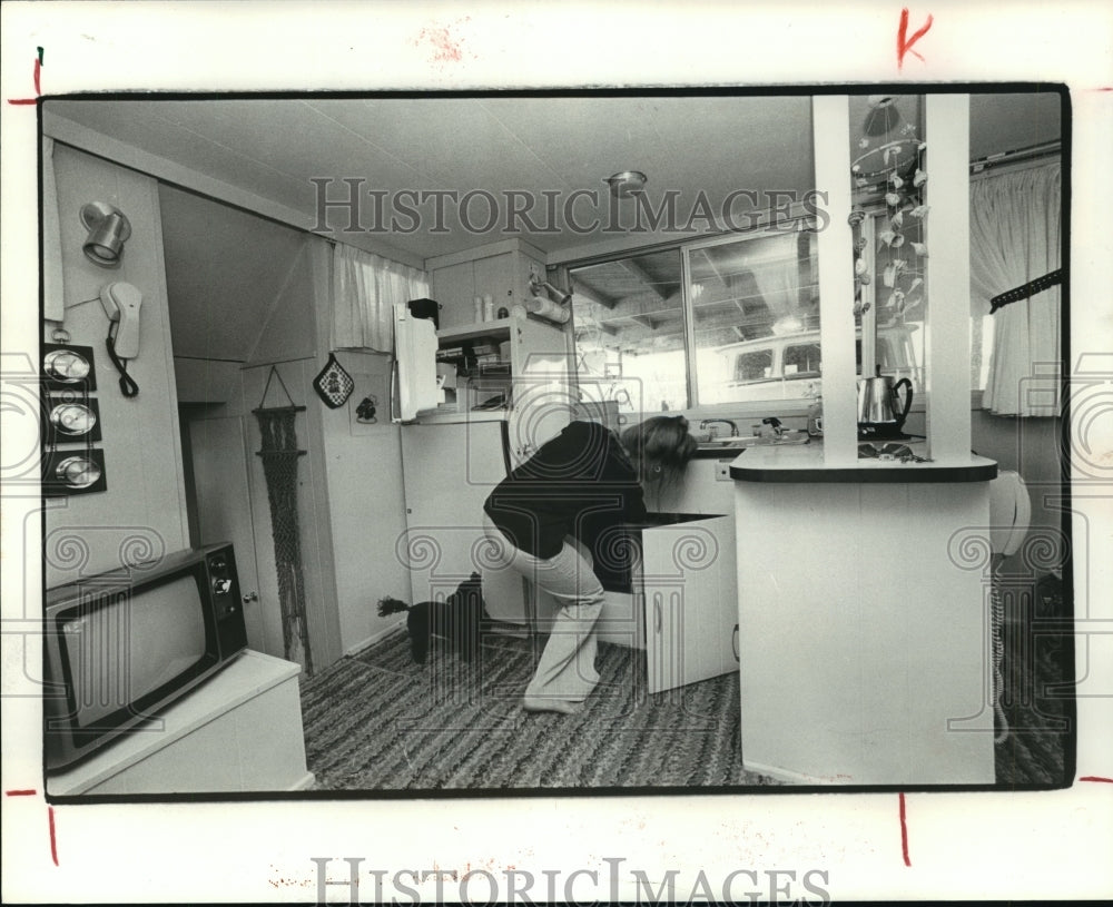 1979 Woman in her houseboat kitchen - galley - Historic Images