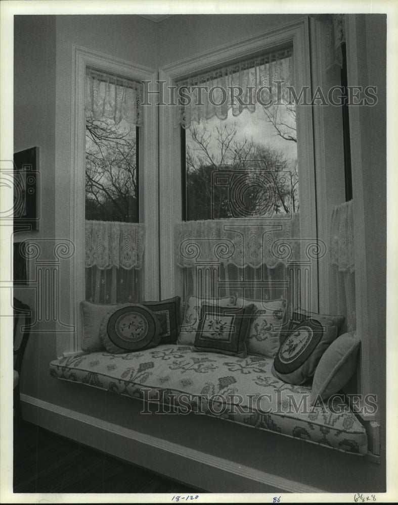 1985 Curtains and pillows at living room window seat - Historic Images