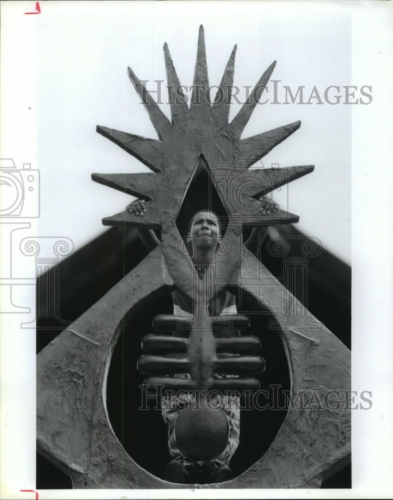 1992 Ronnie Duplechan climbs on sculpture at Hermann Park in Houston - Historic Images