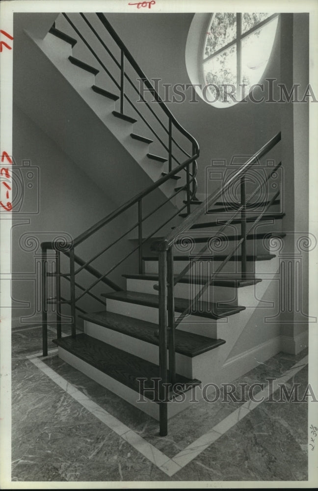 1984 Interior oak stairway and round window in Houston home - Historic Images