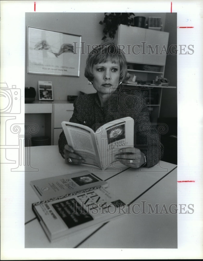 1991 Leader of Houston Hemlock Society, Kay Staley reads book - Historic Images