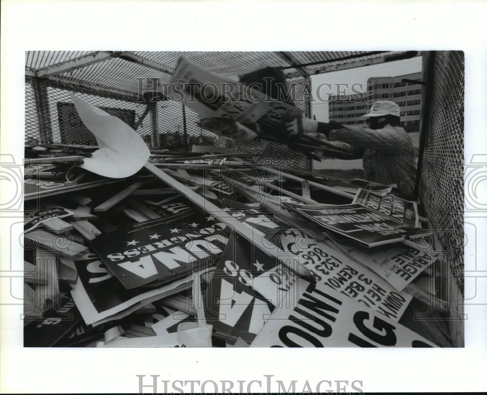 1992 Artvel Williams hurls political signs into bin in Houston - Historic Images