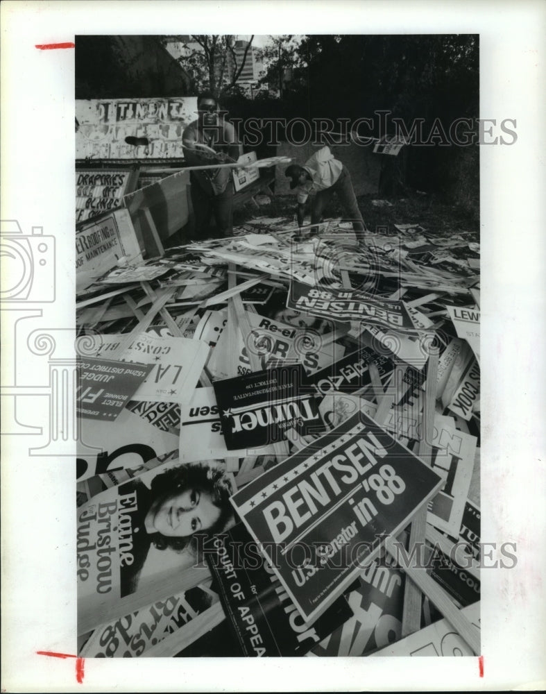 1988 Utility workers pile up old political signs in Houston, Texas - Historic Images
