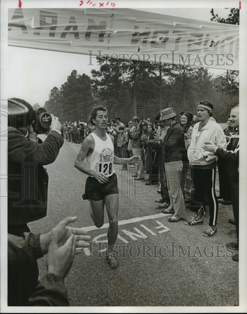 1977 Houston Marathon runner #128 crosses finish line - Historic Images