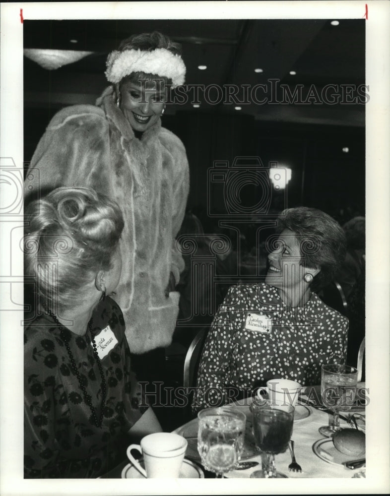 1988 Women admire mink coat at Houston Junior Women's Club - Historic Images