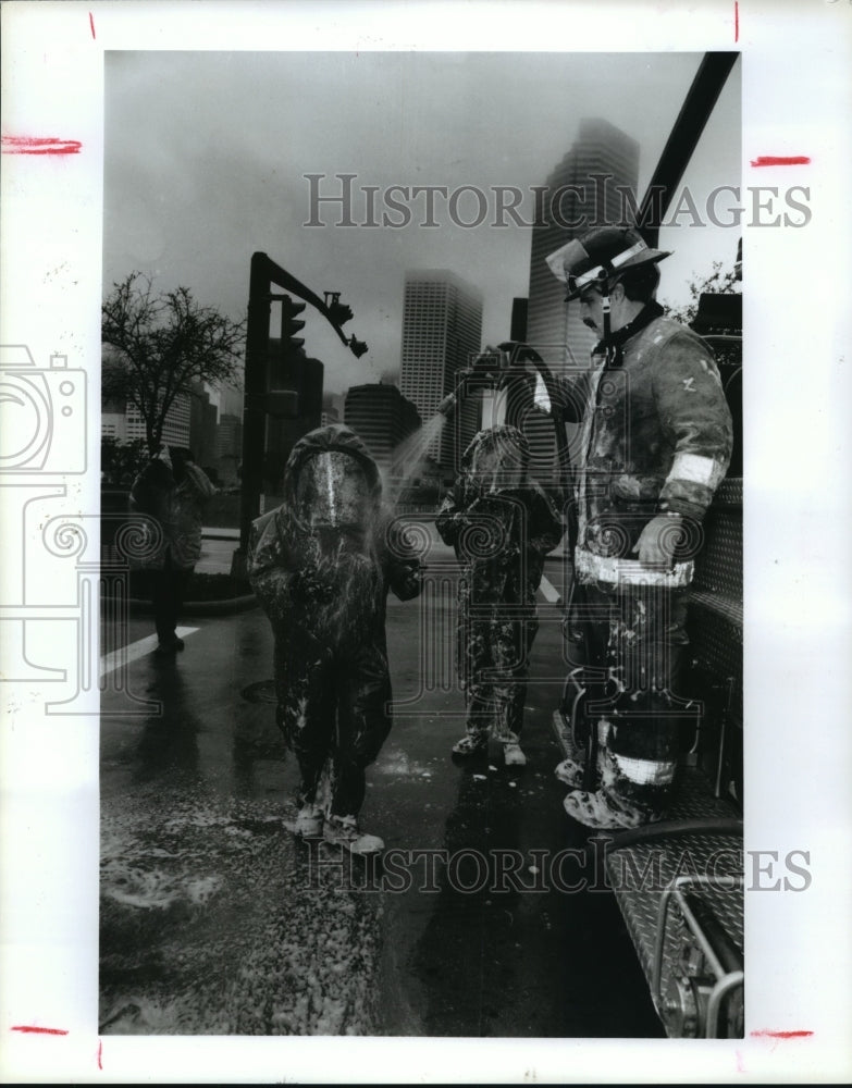1992 Houston firemen get "decontaminated" at mock chemical spill - Historic Images