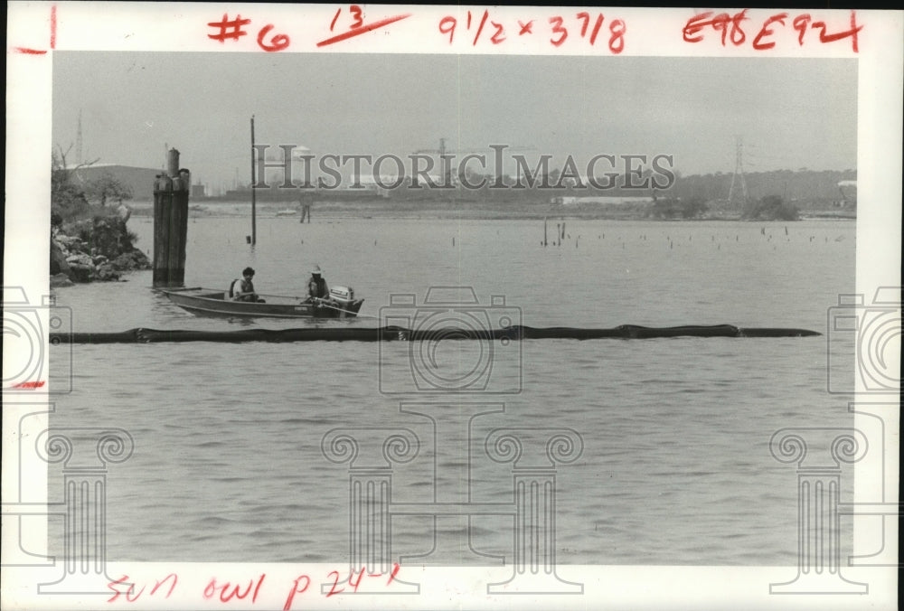 1979 Workers tow containment boom in place at Houston Ship Channel - Historic Images