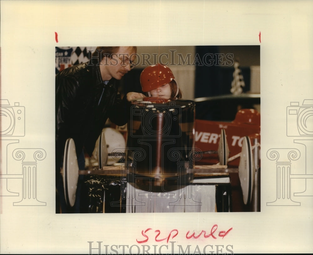 1992 Ramona Abraham sits in soapbox racer at Houston Auto Show - Historic Images