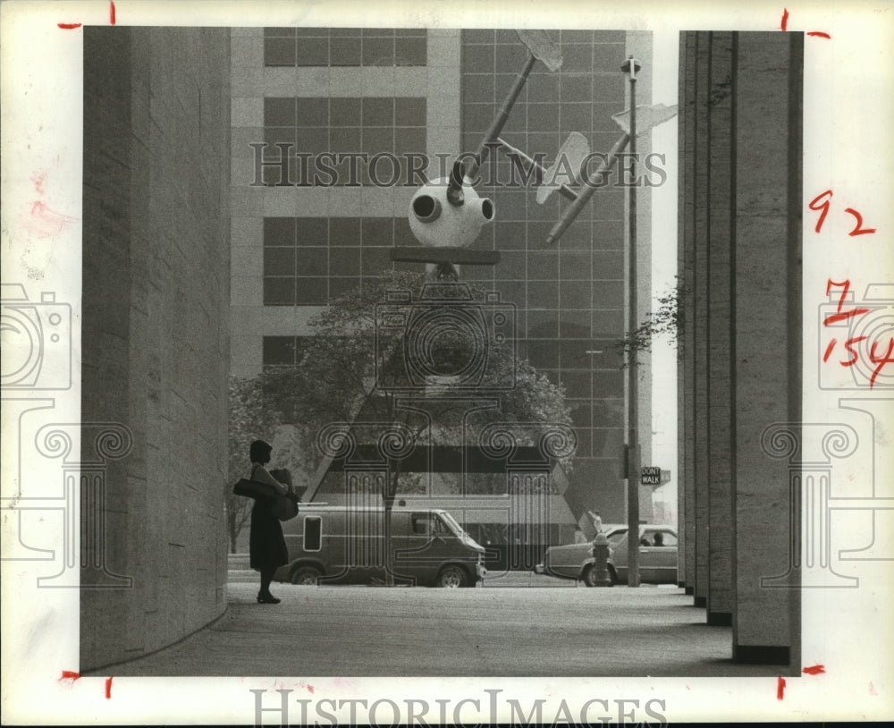 1983 Dorris Williams waits for bus by Jones Hall in downtown Houston - Historic Images