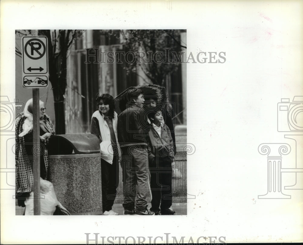 1985 People wait by downtown Houston, Texas street - Historic Images