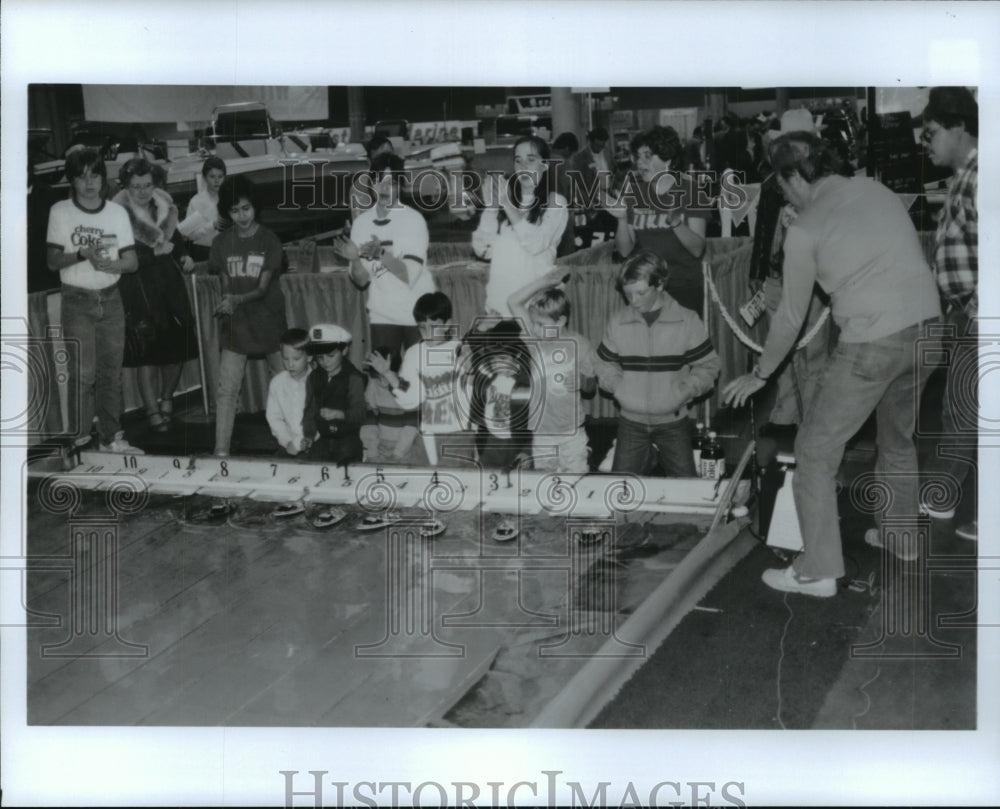 1988 Kids race toy boats at Houston Boat and Travel Show - Historic Images
