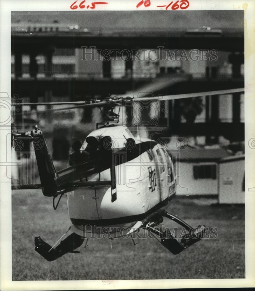 1981 Helicopter prepares to land near Southwest Freeway in Houston - Historic Images