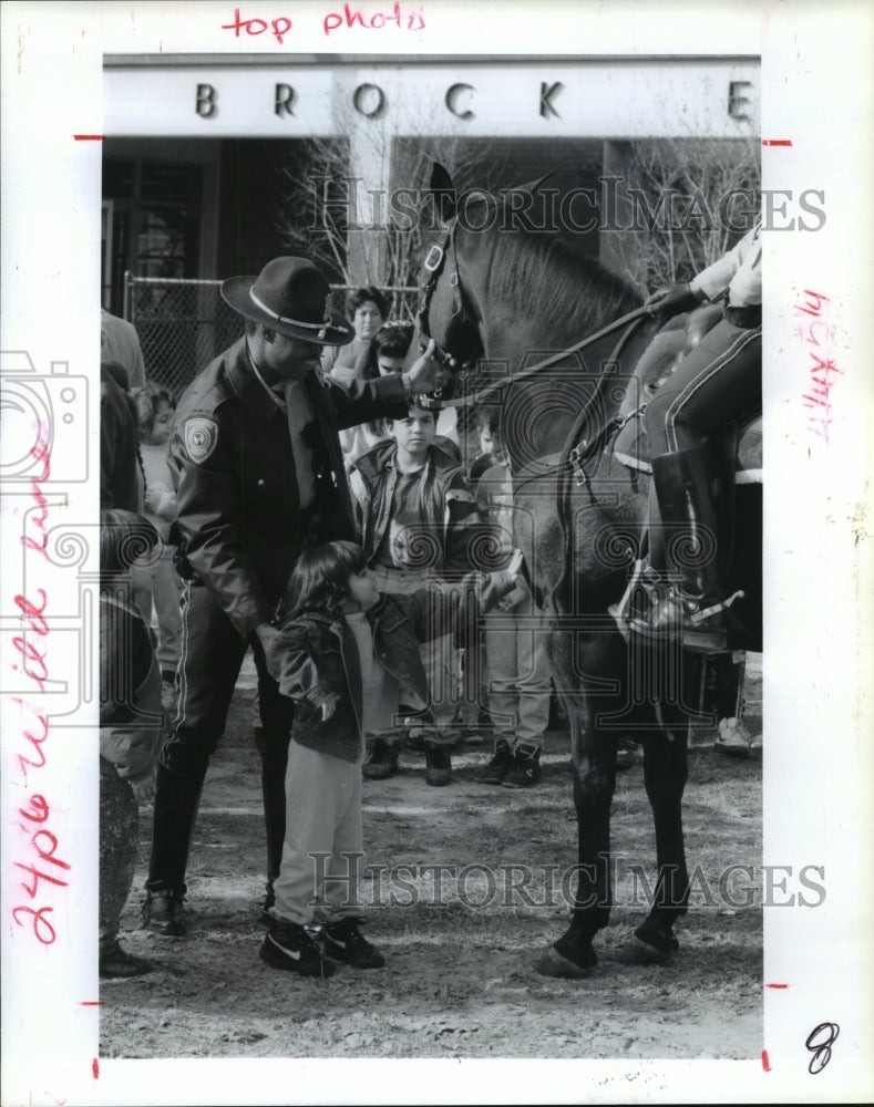 1993 Houston Officer Ken Hogan shows horse to Stacey Capistran - Historic Images