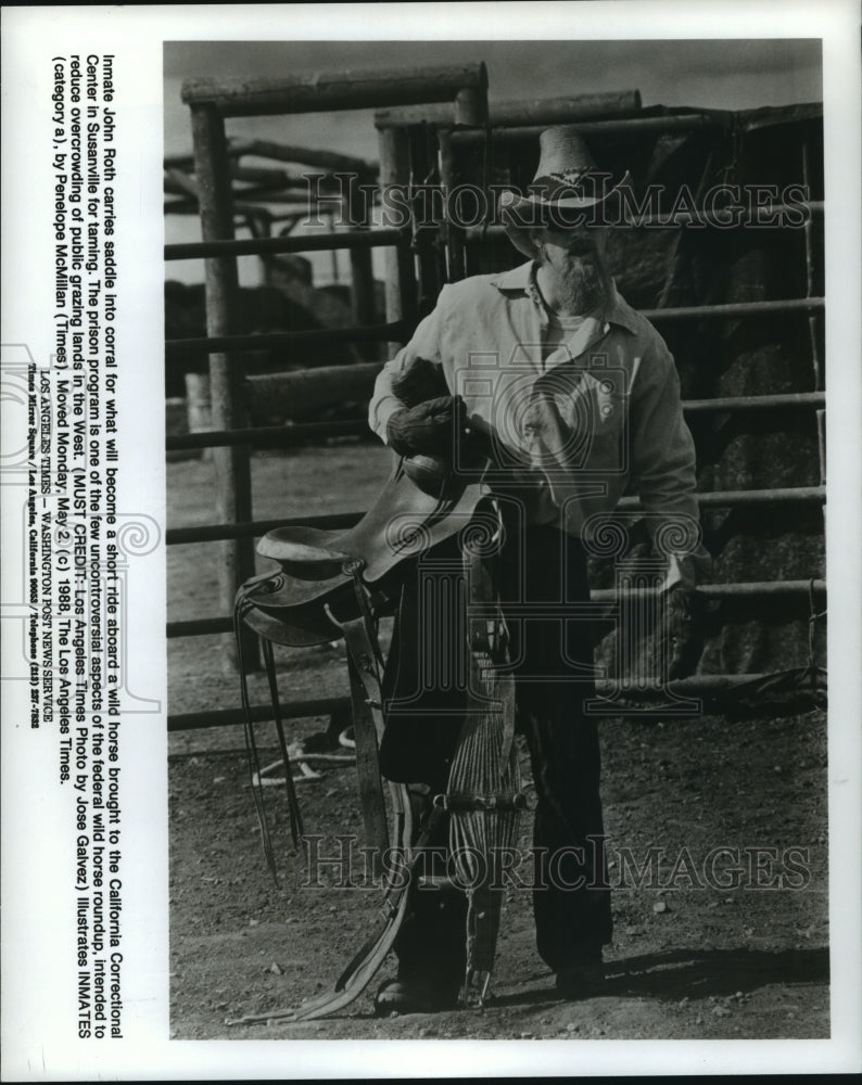 1988 Press Photo CA inmate John Roth carries saddle for wild horse taming- Historic Images