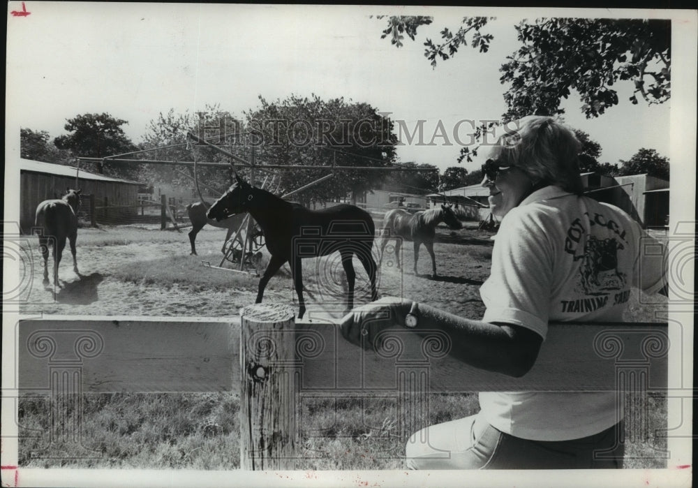 1979 Woman watches horses exercise - Historic Images