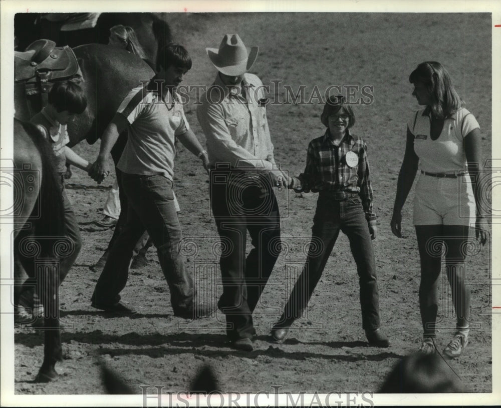 1983 Diana Johnston & others walk away from horses at TX program - Historic Images