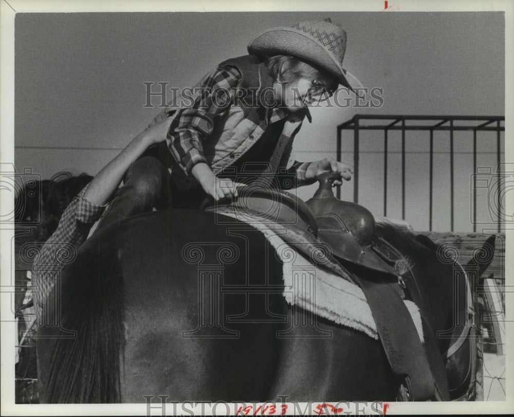 1983 Child mounts horse at a program in Texas - Historic Images