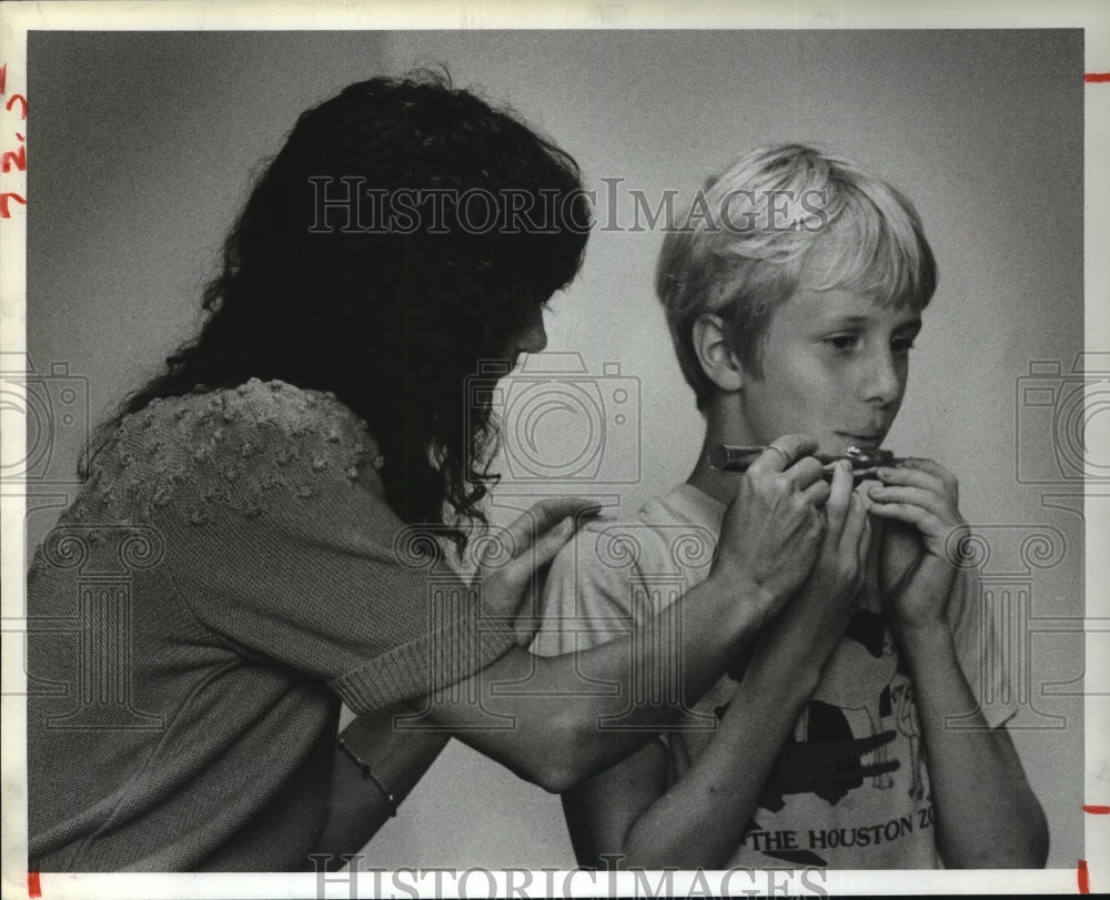 1983 Flutist Heidi Straube shows Miles Johnson how to play - Historic Images