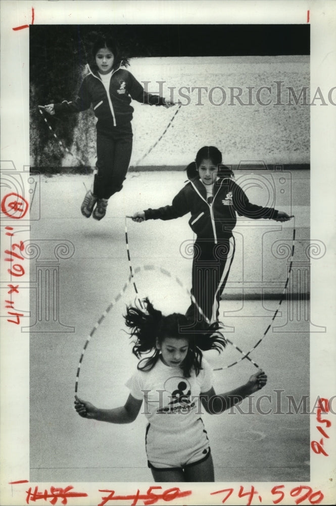 1981 Three Southmayd Elementary students jump rope in Houston - Historic Images