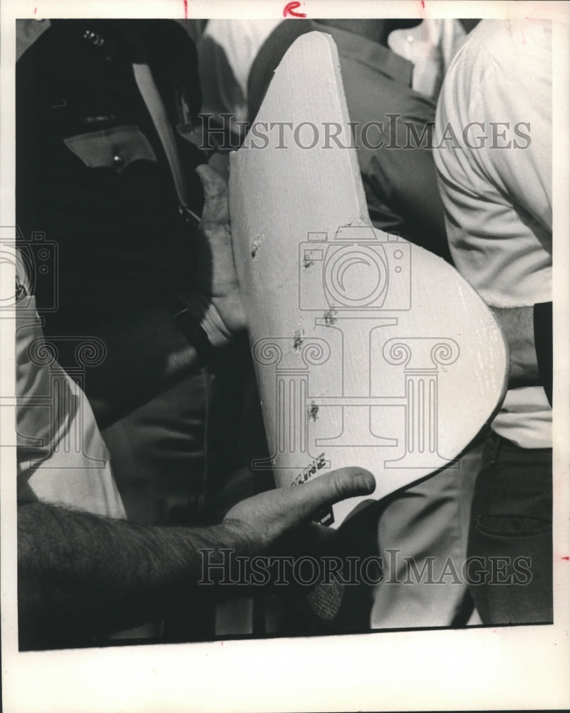 1970 Alan Aronstein of sheriff&#39;s department holds bullet-proof vest - Historic Images
