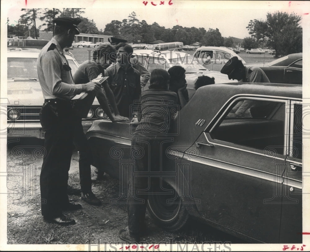 1970 Officer questions youth near Sam Houston High after scuffle, TX - Historic Images