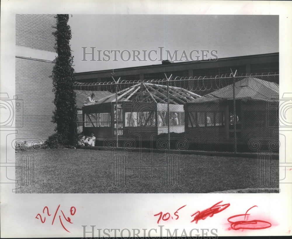 1981 High fence surrounds Huntsville Prison tents in Texas - Historic Images