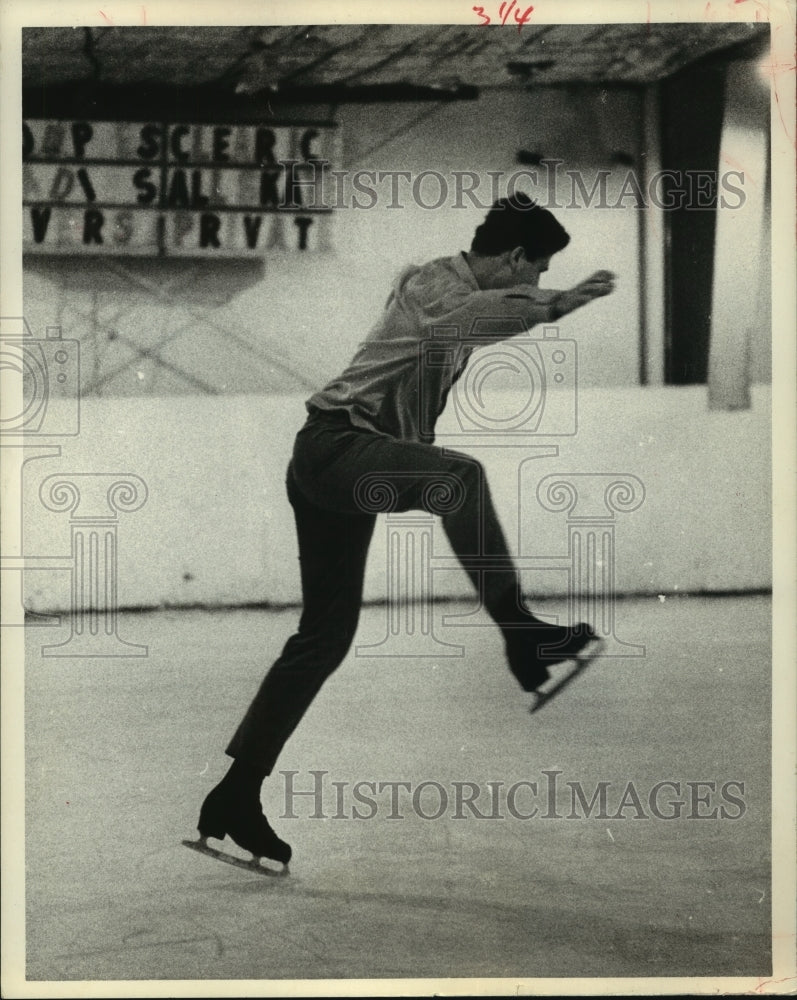 1969 Man leaps as he ice skates in Houston - Historic Images