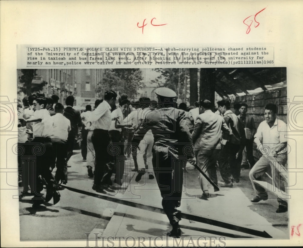 1965 Policeman chase away protesting students in Lima, Peru - Historic Images