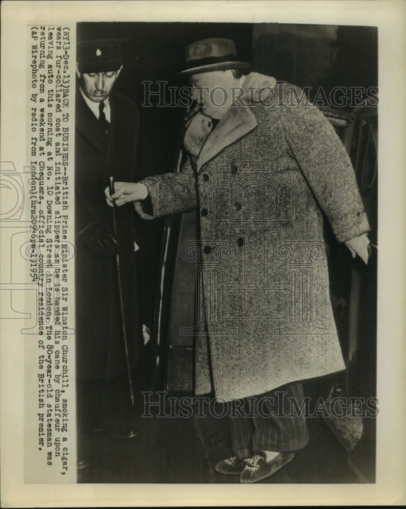 1954 Winston Churchill exits car in London wearing slippers - Historic Images