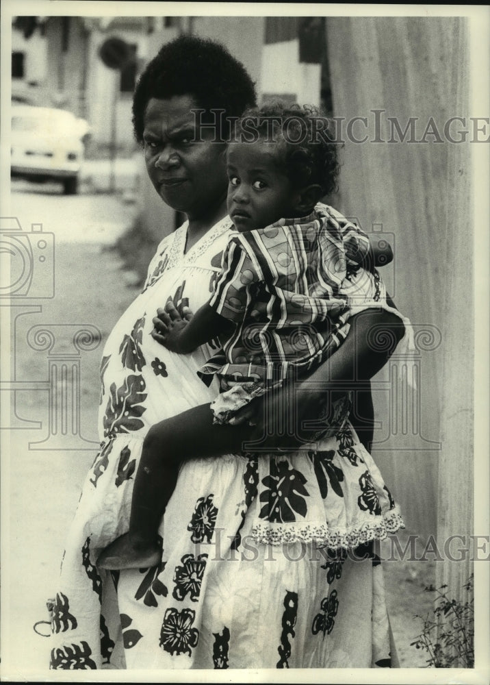 1973 Melanesian mother holds child on street in Vila,  New Hebrides - Historic Images