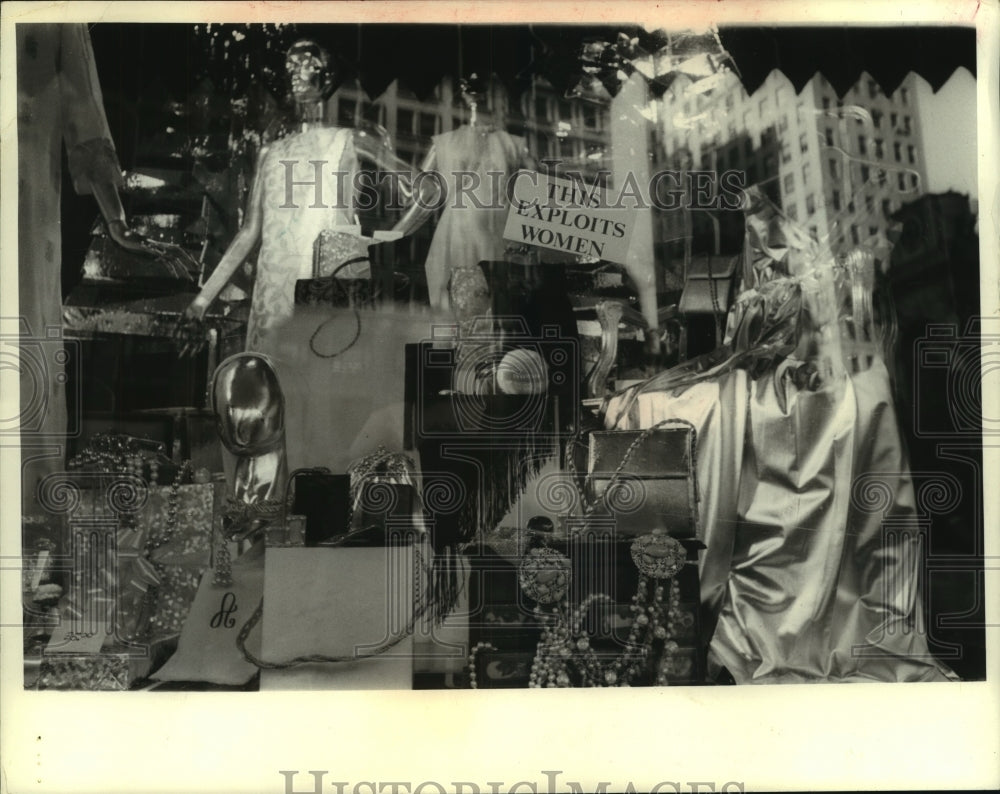 Sign in fashion store window display says &quot;This Exploits Women&quot; - Historic Images
