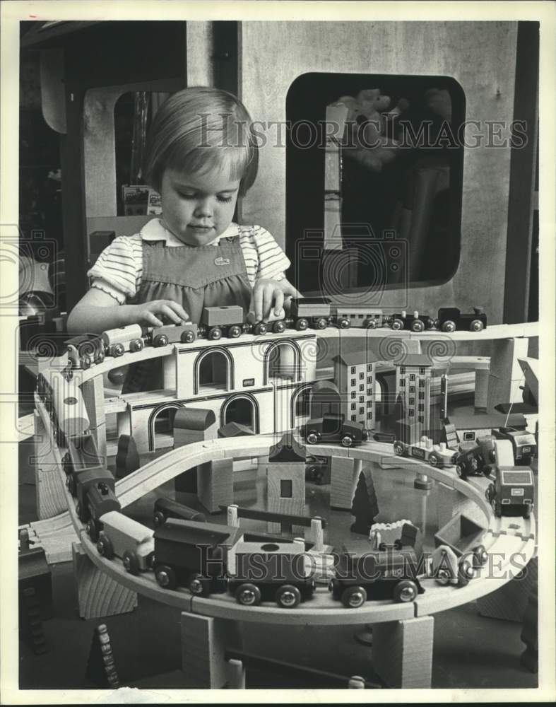 1984 Press Photo Julie Quale plays with Wooden Brio toy train set, Houston Texas- Historic Images