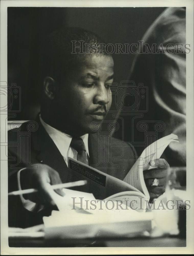 1965 Asberry Butler reviews papers at conference table-Historic Images