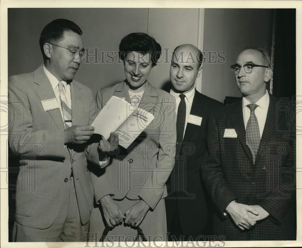 1956 Press Photo Camp Cancer National Conference attendees look over program. - Historic Images