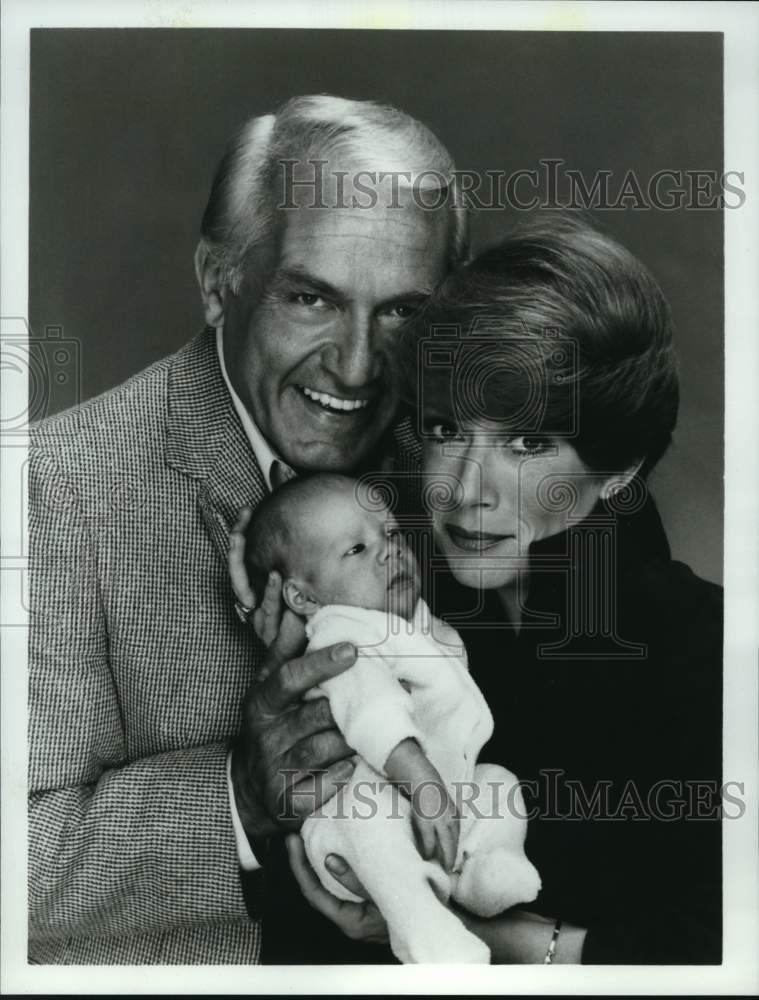 1983 Press Photo Ted Knight, Nancy Dussault hold baby in "Too Close for Comfort" - Historic Images