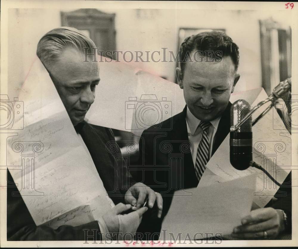 1961 Representatives W. H. Miller and Don Garrison look at petition - Historic Images