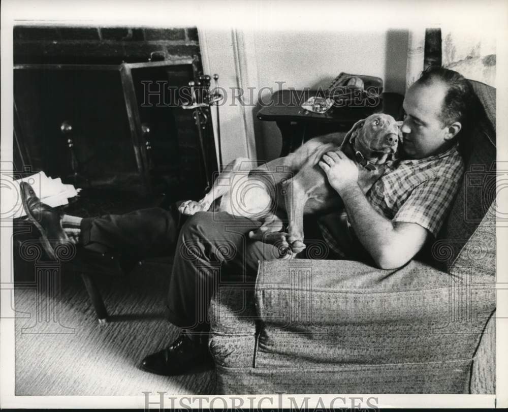 1963 Paul Haney relaxing at home with the family pet dog in his lap.-Historic Images