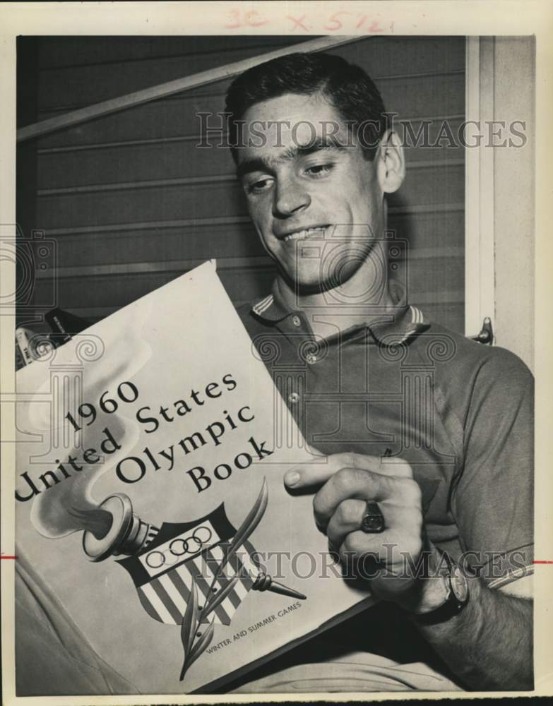 1964 Press Photo Olympian Fred Hansen looks at 1960 Olympic Book - hcb04466 - Historic Images