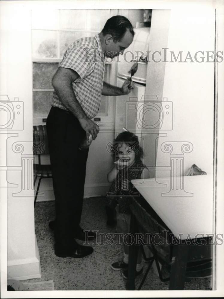 1963 Paul Haney with one of his children.-Historic Images