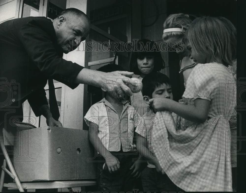 1964 Bill Harrod handing out fruit to children, Houston, Texas-Historic Images