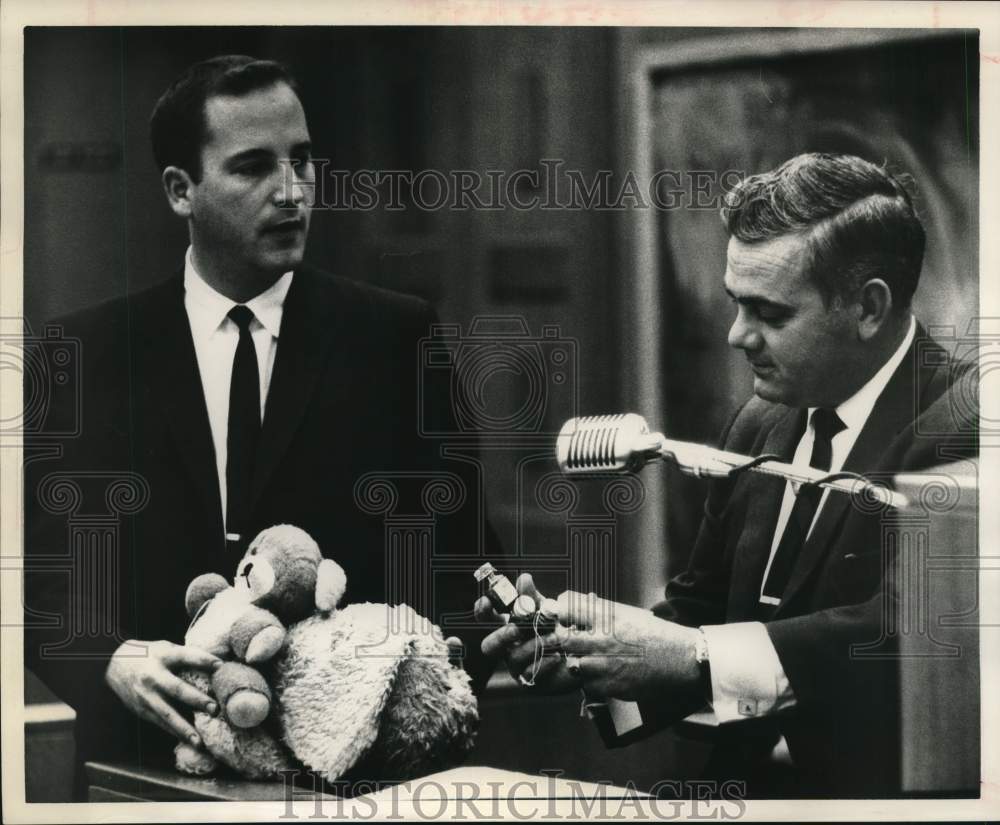 1964 District Attorney Bob Musslewhite shows toys to H. B. Hightower-Historic Images