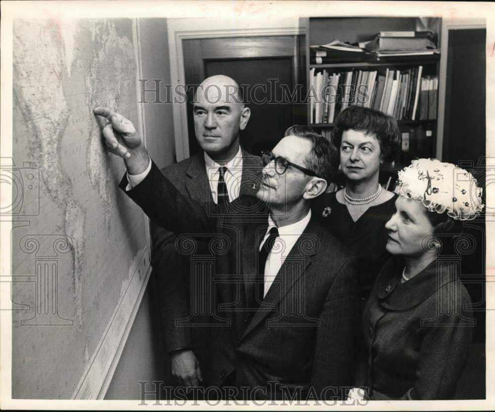 1962 James Hughes, Beau Wendt point out travels on map to wives-Historic Images
