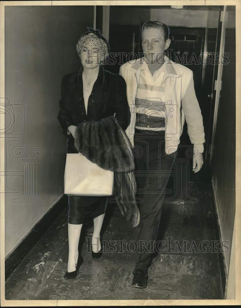 1964 Candace Mossler and son Norman walk down hallway-Historic Images