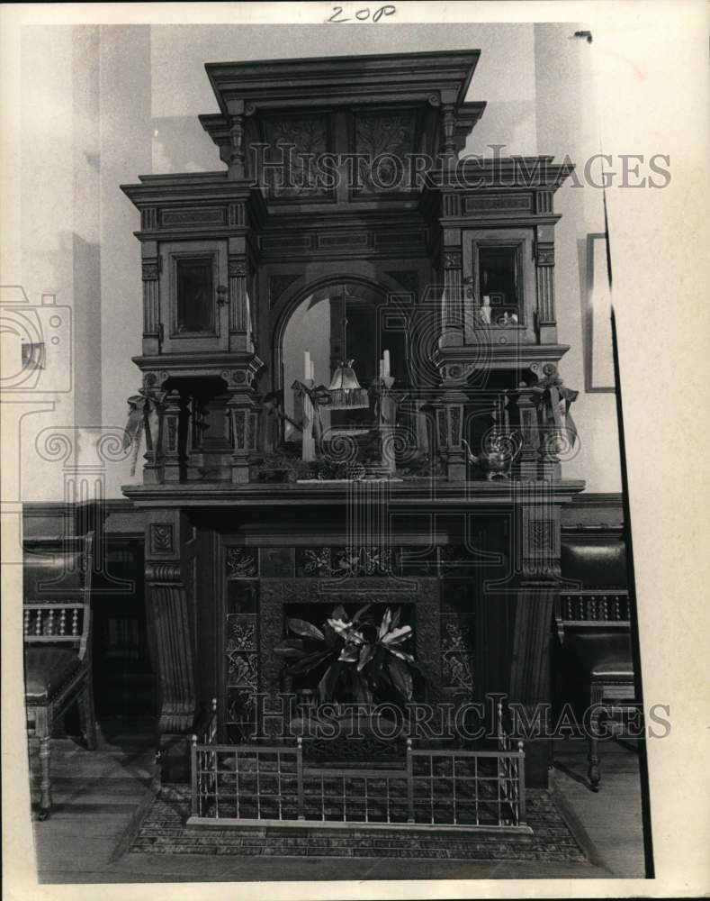 1967 A fireplace with ornate carvings, original tiles, brass railing-Historic Images