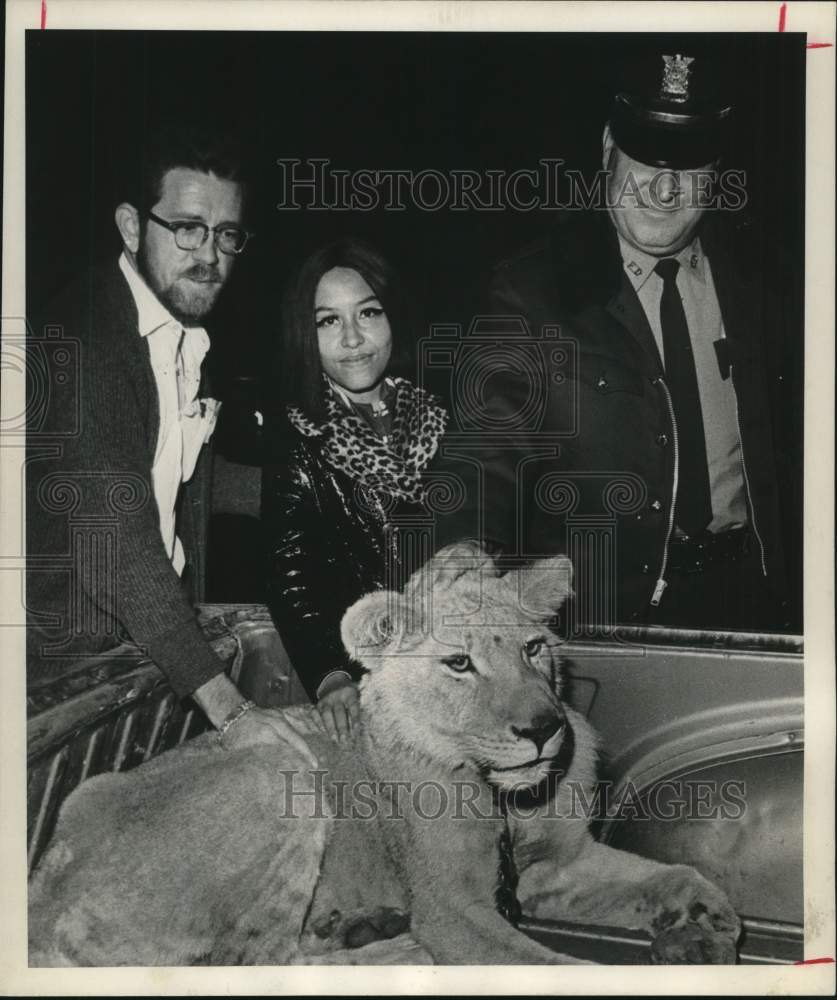 1971 Press Photo Patrolman M.K. Kulhanek guards lion rented by John Jackson.- Historic Images