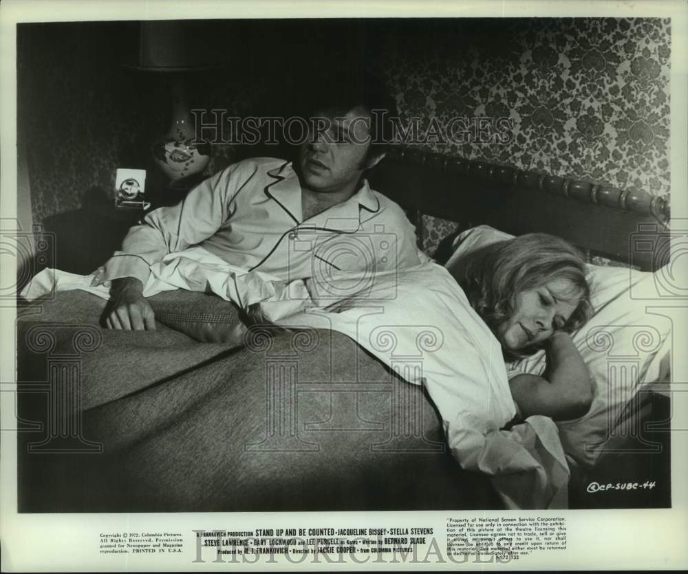 1972 Couple in bed in scene from movie 