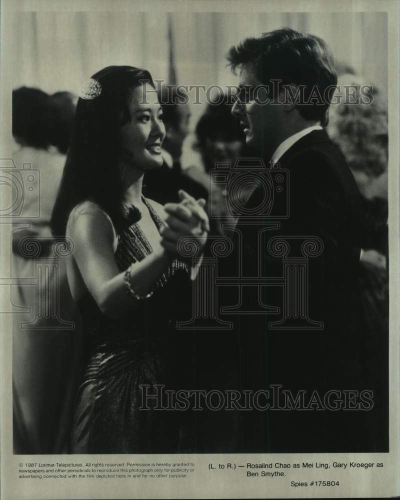 1987 Press Photo Rosalind Chao and Gary Kroeger in a scene from "Spies" - Historic Images