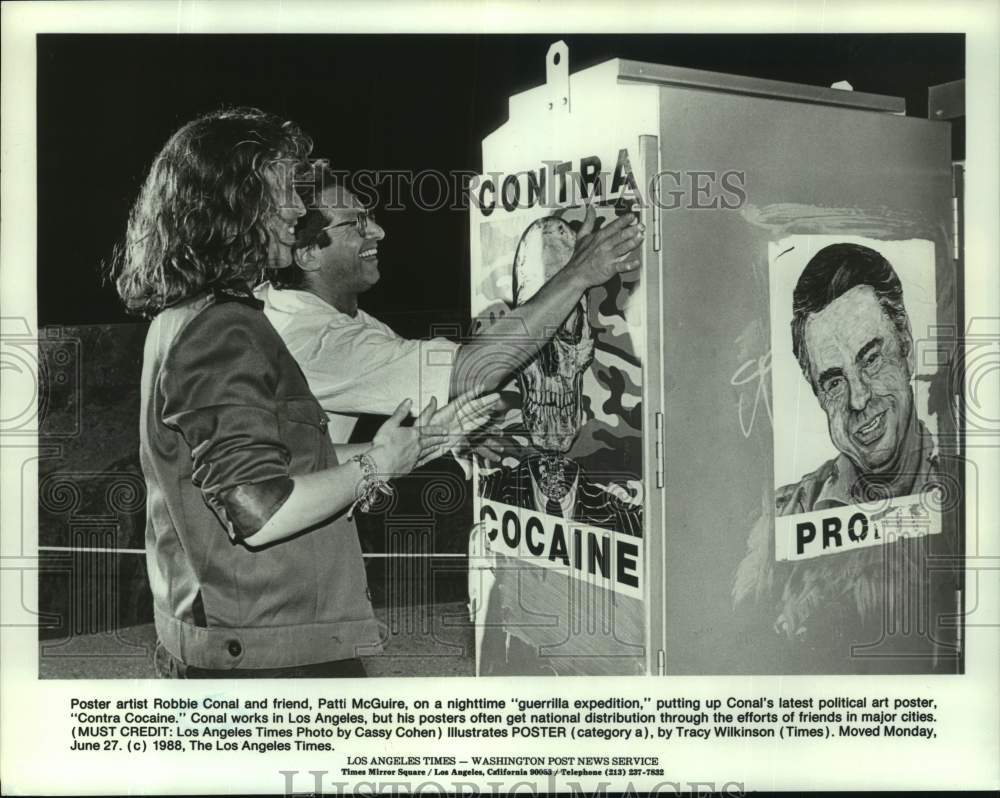 1988 Press Photo Artist Robbie Conal &amp; Patti McGuire Putting Up Posters - Historic Images