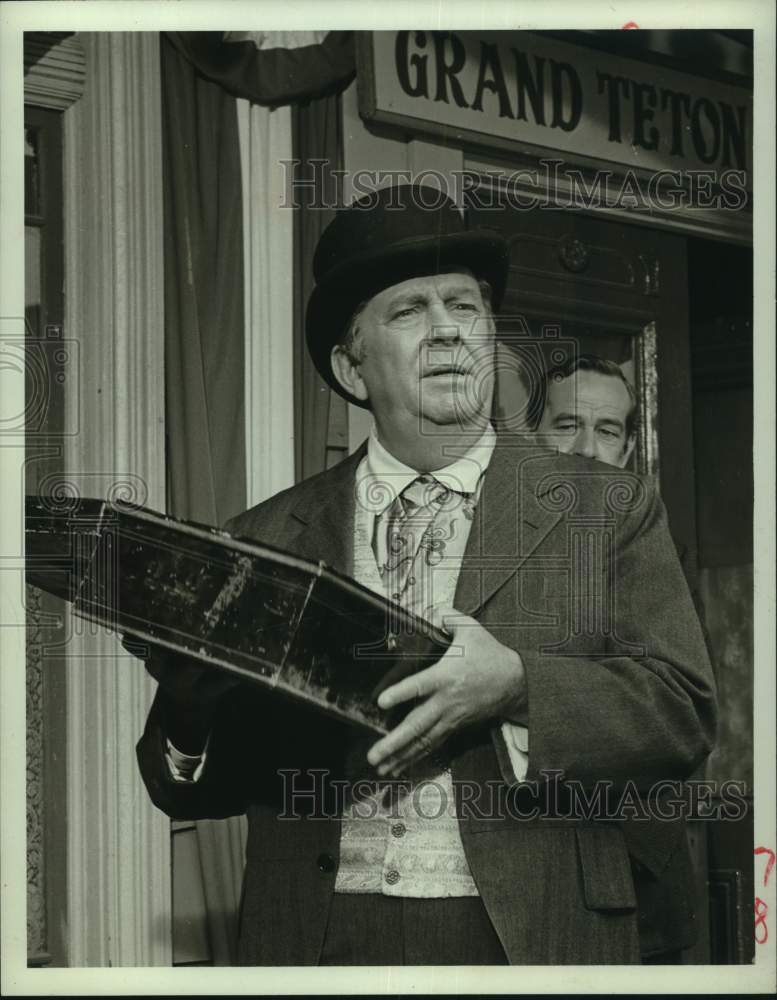 1964 James Dunn holds holds box in television scene-Historic Images